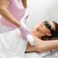 Hair removal by laser hair removal caucasian young woman lies couch with protective glasses procedure