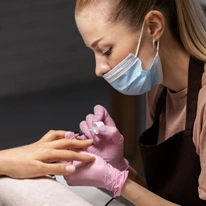 Nail art professional working client nails