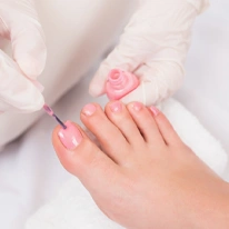 Woman getting her toenails painted